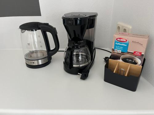 a black coffee maker and a box on a counter at Hinter der Alten Post in Annaberg-Buchholz