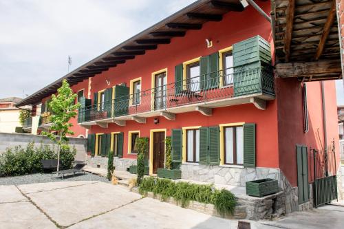 a red building with colorful windows and balconies at Agriturismo Ca' del Clat in Bagnolo Piemonte