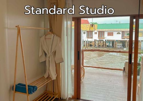 a robe hanging in a room with a window at De' Ocean land เดอโอเชี่ยนแลนด์ เกาะล้าน in Ko Larn