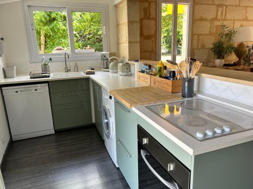 a kitchen with a sink and a counter top at La Bohème in Galgon
