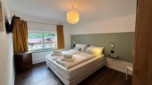 a bedroom with a bed and a window at Villa Lucia appartamento Fiore in Padola