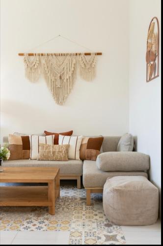 a living room with a couch and a coffee table at BlueDomeHouse Lt 1 in Kanggraksan