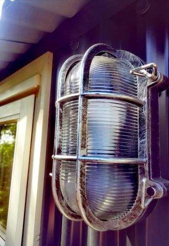 a fan hanging on the side of a house at Ty Bach Glas in Llanhowell