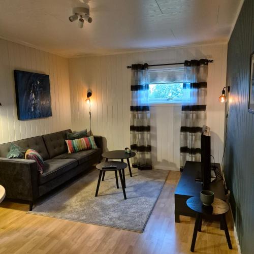 a living room with a couch and a table at Leilighet Ytrebyen Vadsø in Vadsø