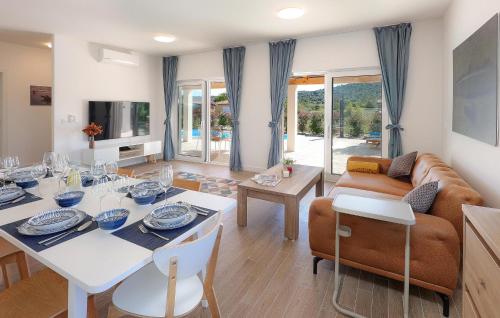 a living room with a table and a couch at Lovely Home In Pasman in Pašman