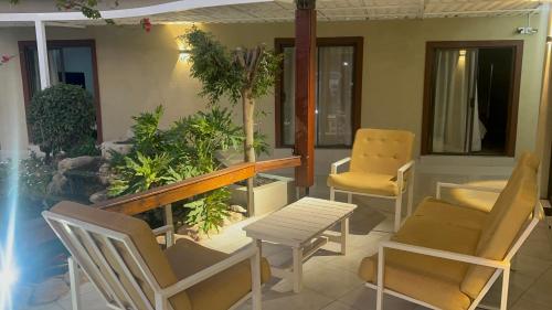 a room with chairs and a table and a table and chairs at Lamamie Suite Lodge in Thohoyandou