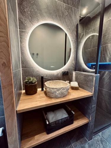 a bathroom with a sink and a mirror at Appartement de Charme - Le Large in La Tente-Verte