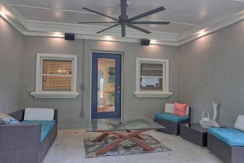 a living room with a ceiling fan and a table at Battery Place in Savannah