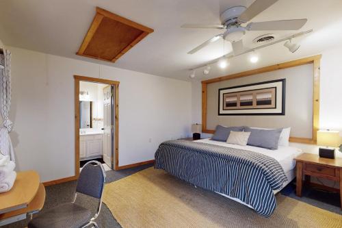 a bedroom with a bed and a table and a chair at Sunset Peaks in Accident