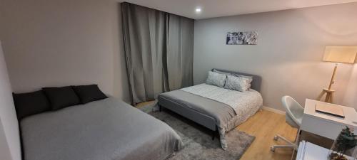 a small bedroom with a bed and a chair at Confortável ensuite 1 privado centro da cidade in Póvoa de Varzim