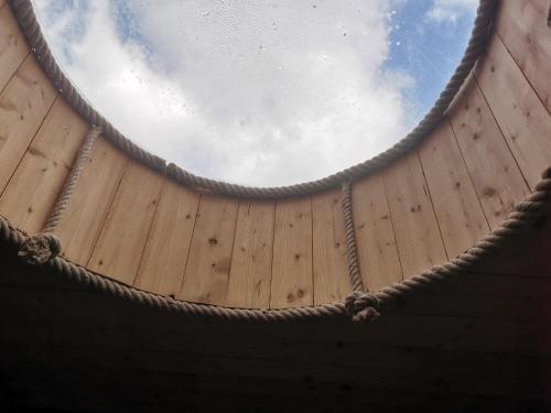 an overhead view of a wooden ceiling with the sky in the background at Gîte de ferme équestre in Auzet