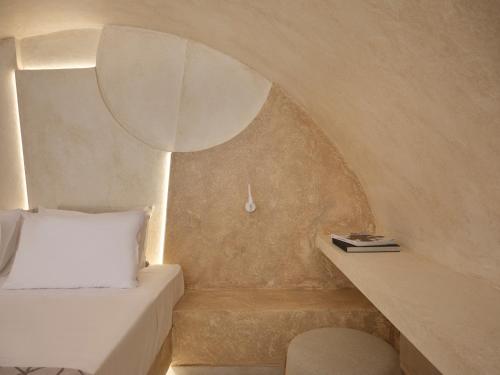 a small room with a bed and a table at Heyday Luxury Suites in Perissa