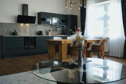 a kitchen with a table and a dining room at Residence Black Eagle Lubmin Strand in Lubmin