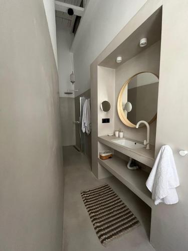 a bathroom with a sink and a mirror at The Bridge House Plomari in Plomari