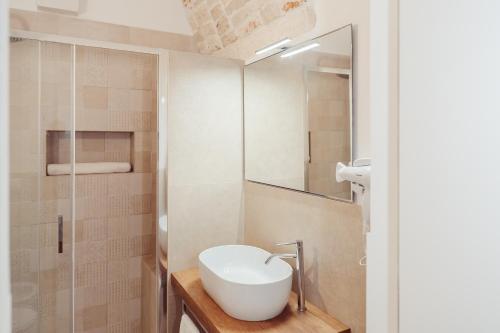 a bathroom with a sink and a mirror at Le Luci del Borgo B&B in Sammichele di Bari
