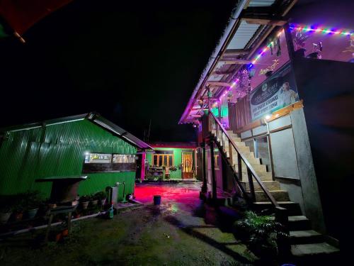 a group of buildings lit up at night at Village Cafe Homestay in Kalimpong