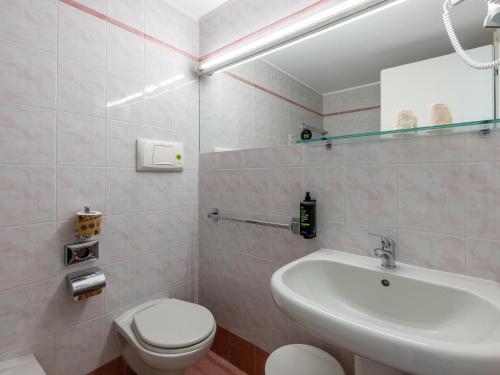 a bathroom with a white sink and a toilet at B&B Hotel Borgaro Torinese in Borgaro Torinese