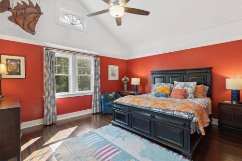 a bedroom with red walls and a bed in a room at Beach Nirvana in Westhampton Beach