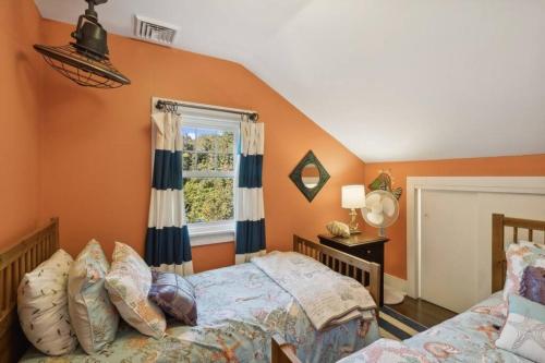 a bedroom with two beds and a window at Beach Nirvana in Westhampton Beach
