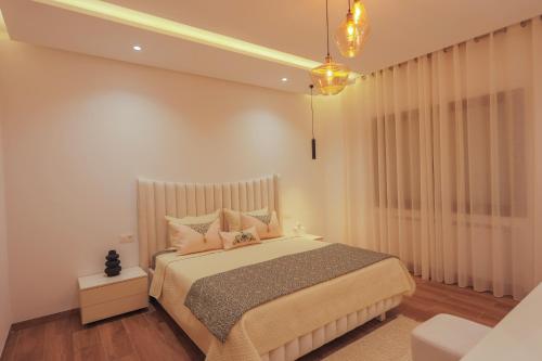 a bedroom with a large bed with pillows at Bright and Cozy New 3 Bedrooms Apartment in Tunis