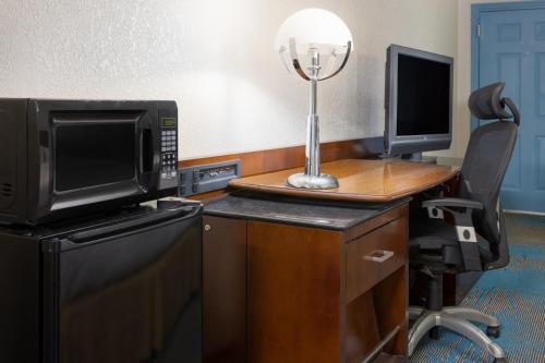 a room with a desk with a computer and a chair at Days Inn by Wyndham Columbia in Columbia