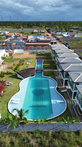 an overhead view of a swimming pool at a resort at pousada sol e violao smg in São Miguel do Gostoso