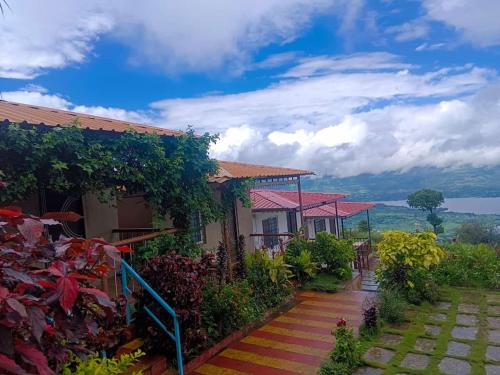 a house with a staircase leading to a garden at Dream House in Satara