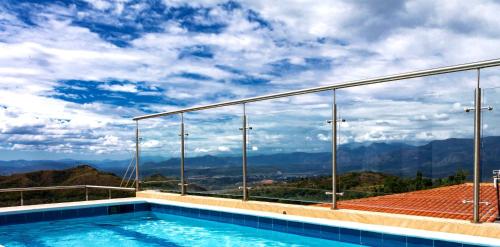 a swimming pool with a view of the mountains at Casas Campestres Los Miradores de Fruworld in Carmen de Apicalá