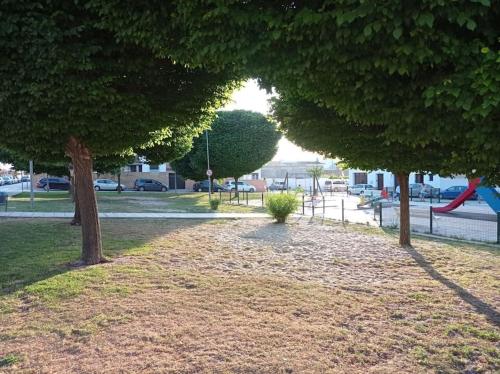 a park with trees and a playground with a slide at Acogedor loft a 30 minutos de la playa y montaña in Lebrija