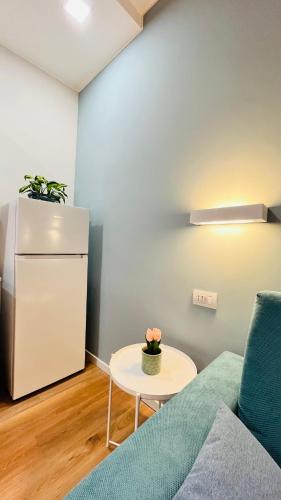 a living room with a couch and a refrigerator at Leila's home forever - casa vacanze in Bergamo
