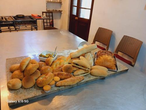 a table with a tray of bread and pastries at Dolphin Village in Kalpitiya