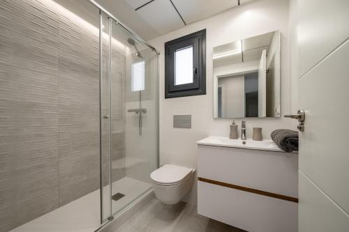 a bathroom with a toilet and a glass shower at Luxury Apartment in Mil Palmeras in Dehesa de Campoamor