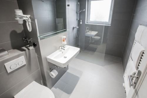 a bathroom with a sink and a toilet at Anna 1908 in Berlin