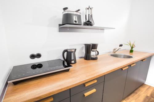 a kitchen with a wooden counter top with a sink at Anna 1908 in Berlin