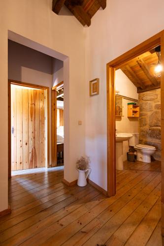 a bathroom with a tub and a toilet in a room at Casa da Aldeia “Póvoa Dão” in Povoa Dao