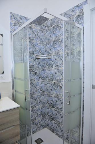 a shower with a glass door in a bathroom at La Dimora In Blu in Bologna