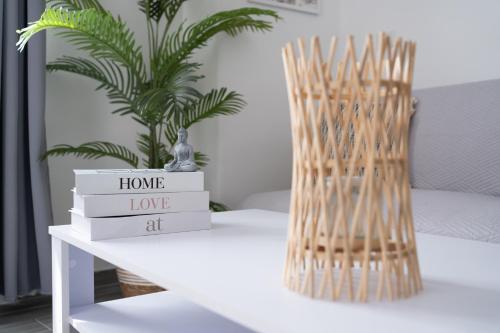 a table with a stack of books and a vase at Appartamento Regina Margherita in Crotone