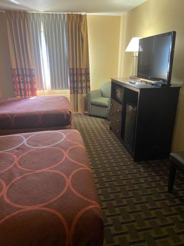 a hotel room with two beds and a flat screen tv at Super 8 by Wyndham Lebanon in Lebanon