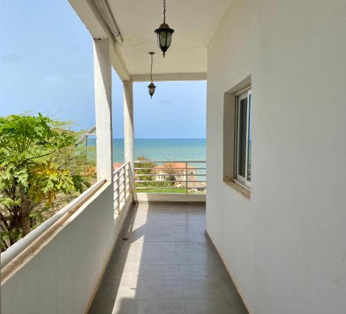 an empty balcony with a view of the ocean at Casa Yoss in Toubab Dialaw