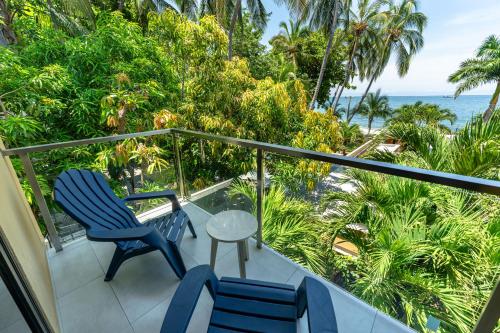 a balcony with two chairs and a table and the ocean at Casa Verano Beach Hotel - Adults Only in Santa Marta