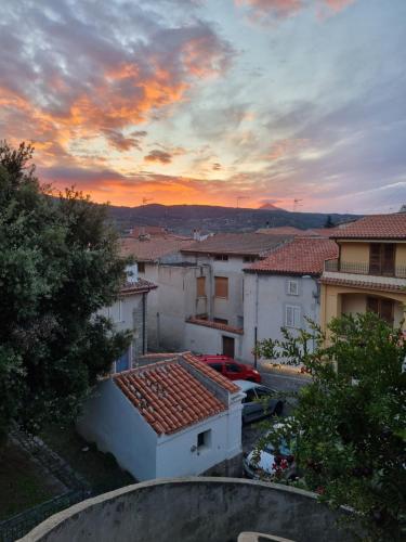 a view of a city with a sunset in the background at Su Hantaru Vetzu in Mamoiada