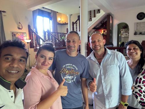 a group of people posing for a picture at Hideaway Homestay kandy in Haloluwa