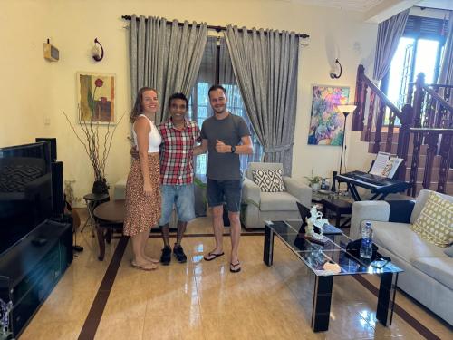 a man and a woman standing in a living room at Hideaway Homestay kandy in Haloluwa