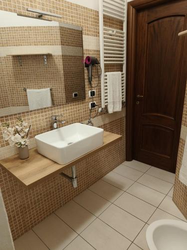 a bathroom with a white sink and a mirror at Le perle 2 di Naxos in Giardini Naxos