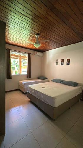 ein Schlafzimmer mit zwei Betten und einer Holzdecke in der Unterkunft Experiência surreal em Àguas de Olivença, Ilhéus BA in Olivença