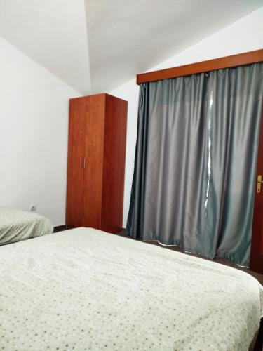 a bedroom with a bed and a window at Mijovic Apartments in Budva