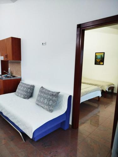 a small room with a bed and a mirror at Mijovic Apartments in Budva