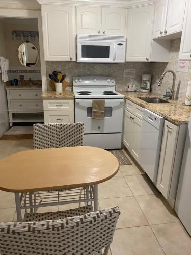 a kitchen with a table and a stove and a sink at Pirates Pointe Resort in Ruskin