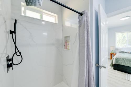 a white bathroom with a shower and a bed at End Unit with Clear Lake Access in NorCal! in Clearlake