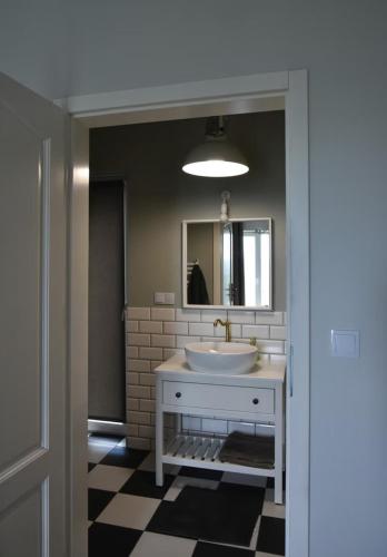 a bathroom with a white sink and a mirror at Siedlisko na Agatowej w Rudnie in Rudno